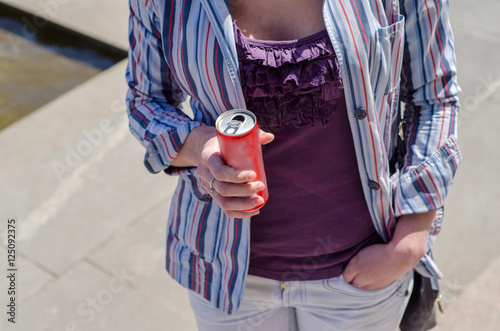 girl walking in city with cola soda