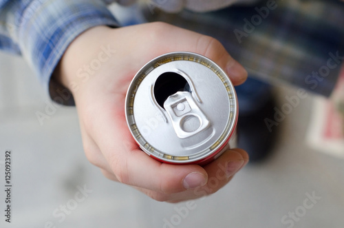 young boy hold  can