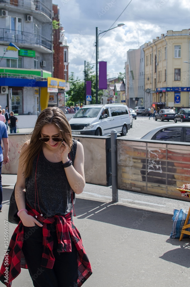 Fototapeta premium Young woman is using her cellphone