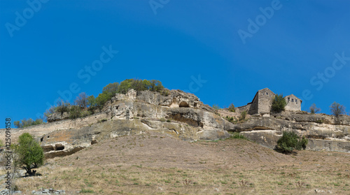 View of the cave city-fortress Chufut-Kale from the southern slope and beams Maryam-Dere