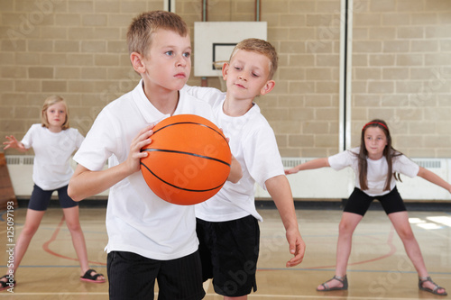 Elementary School Pupils Playing Basketball In Gym © highwaystarz