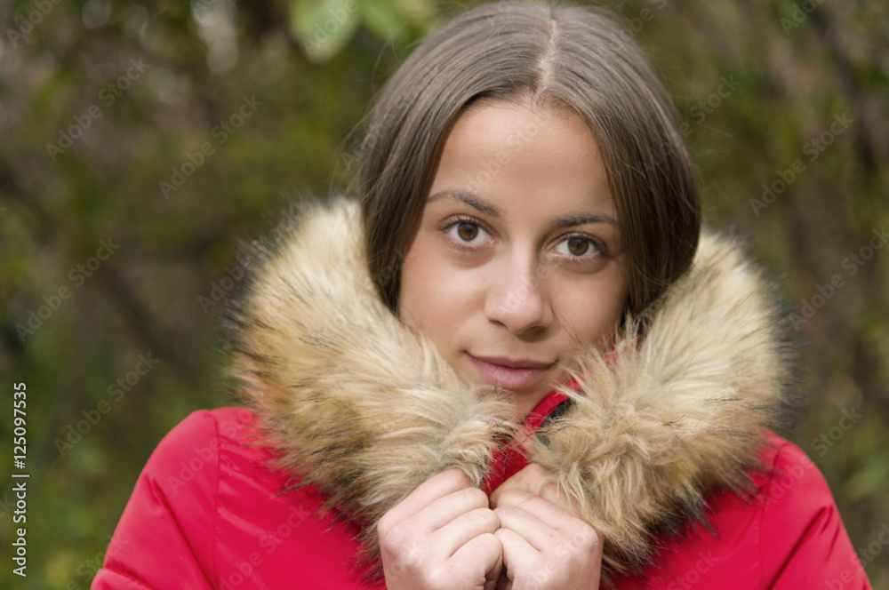 Young woman alone on a forest wearing red overcoat Young woman alone on a forest wearing red overcoat