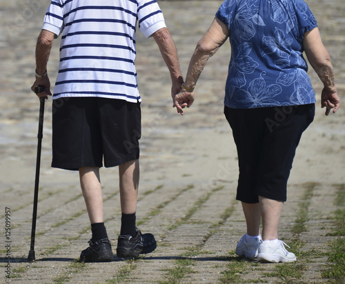 Senior couple walking holding hands - Concept of love and family union