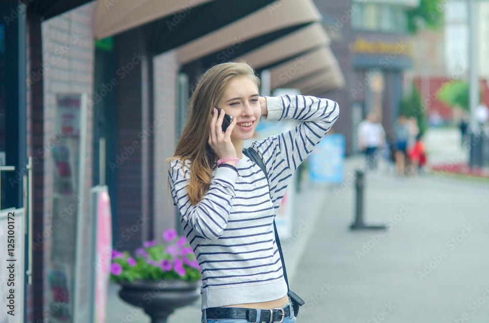 Fototapeta premium Young woman using her phone