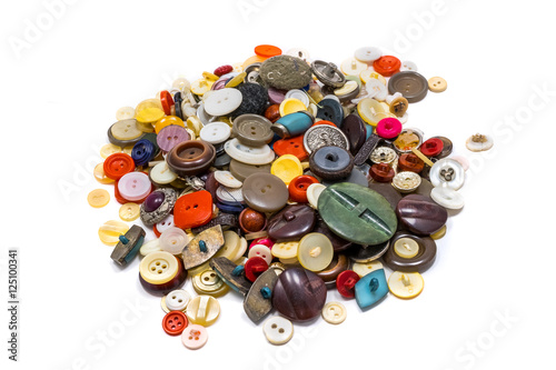 Old various sewing buttons on white background