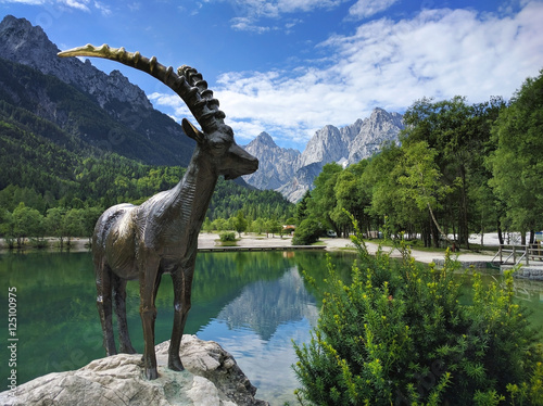 Lake Jasna and mountain goat statue closeup in Kranjska Gora, Sl photo