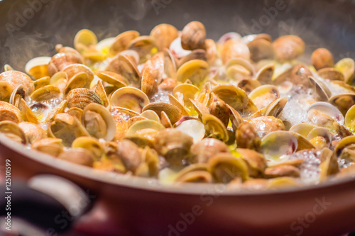 Cooking clams in a pan, Italian food tradition