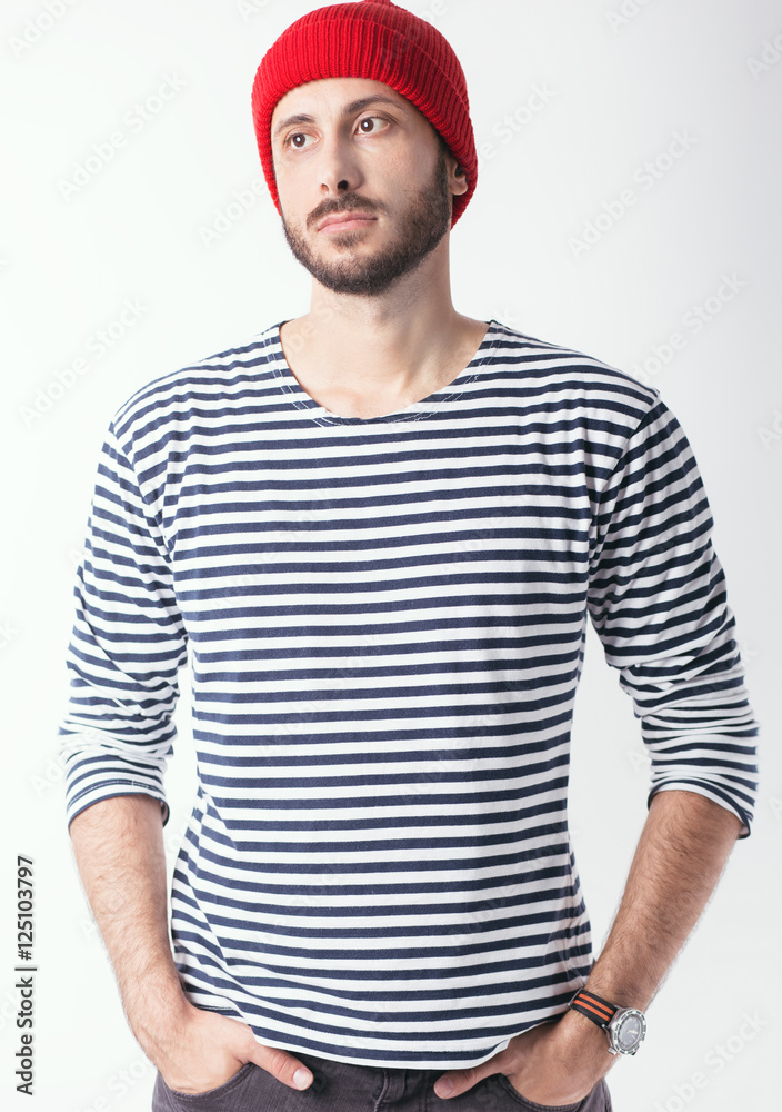 Bearded man with sailor striped shirt and red wool cap