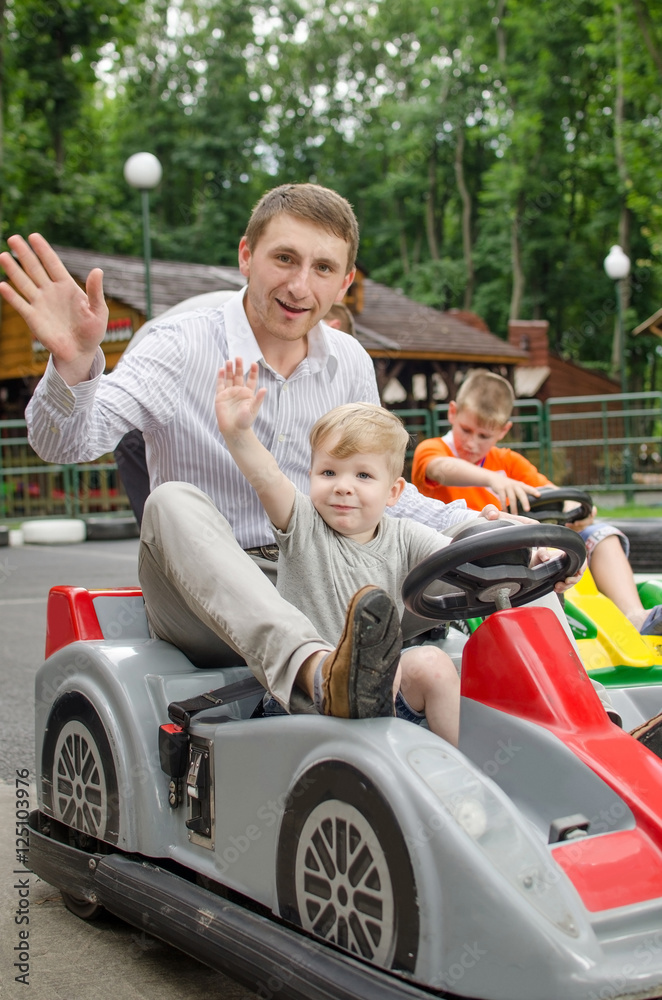 Small baby boy is enjoying driving small car Small baby boy is enjoying driving small car