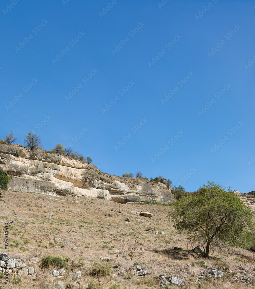 View of the cliffs of the city-fortress Chufut-Kale from the beam Maryam-Dere in the early autumn View of the cliffs of the city-fortress Chufut-Kale from the beam Maryam-Dere in the early autumn