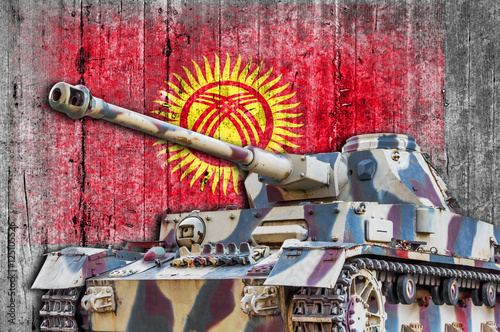 Military tank with concrete Kyrgyzstan flag photo