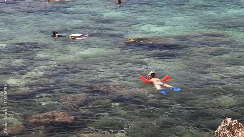 Girl snorkeling in Sharks Cove at Pupukea Beach Park. One of the best snorkeling site on Oahu in Hawaii. photo