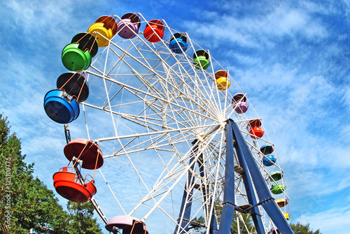 Brightly colored Ferris wheel against the blue sky photo
