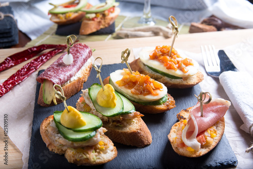 Bruschetta crostini set on a slate plate. The concept of Italian cuisine.