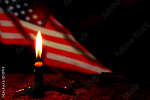 Candles flag funeral mourning in USA with weapons dark background.