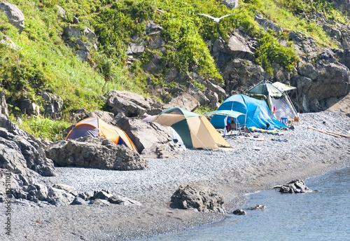 wild tourist camping on desert beach on the russian reserve isle photo