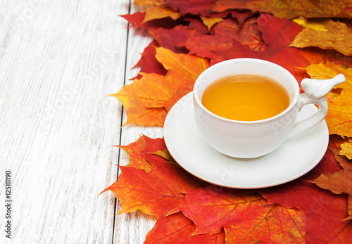 hot tea and autumn leaves