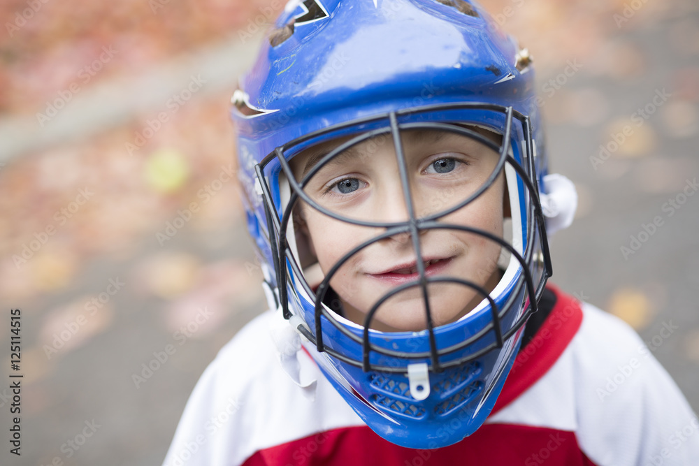 boy dressed to be the goalie in a street hockey game boy dressed to be the goalie in a street hockey game