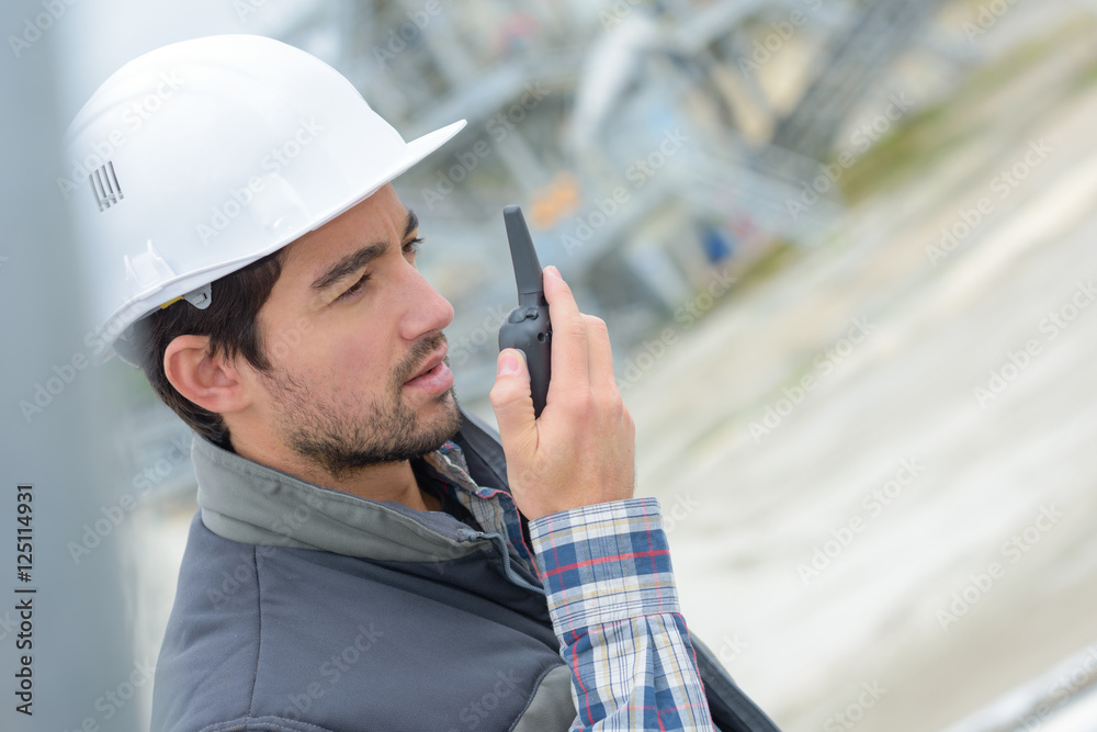 Construction worker using walkie talkie Construction worker using walkie talkie
