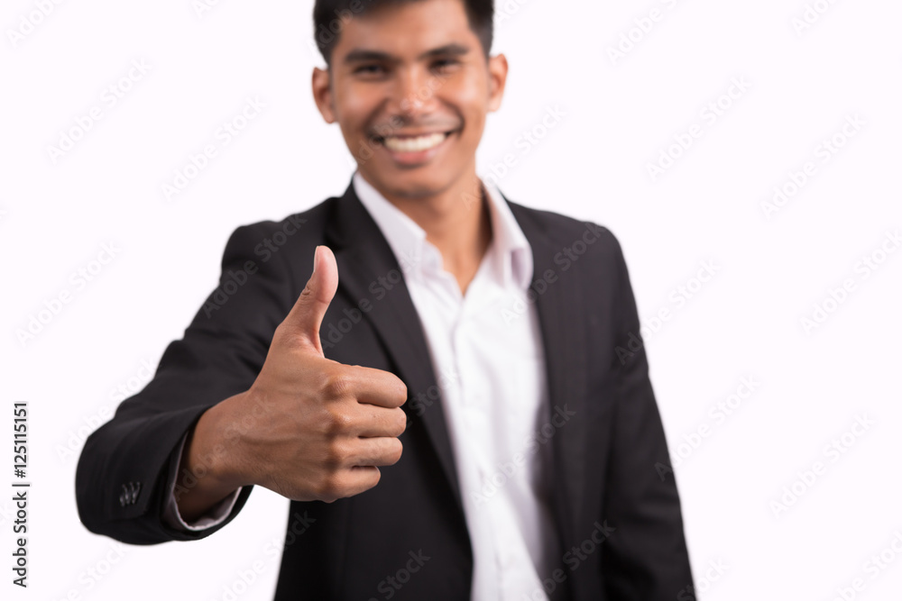 Smiling businessman with thumb up