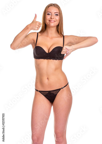 Young sexy woman in black undies gesturing OK