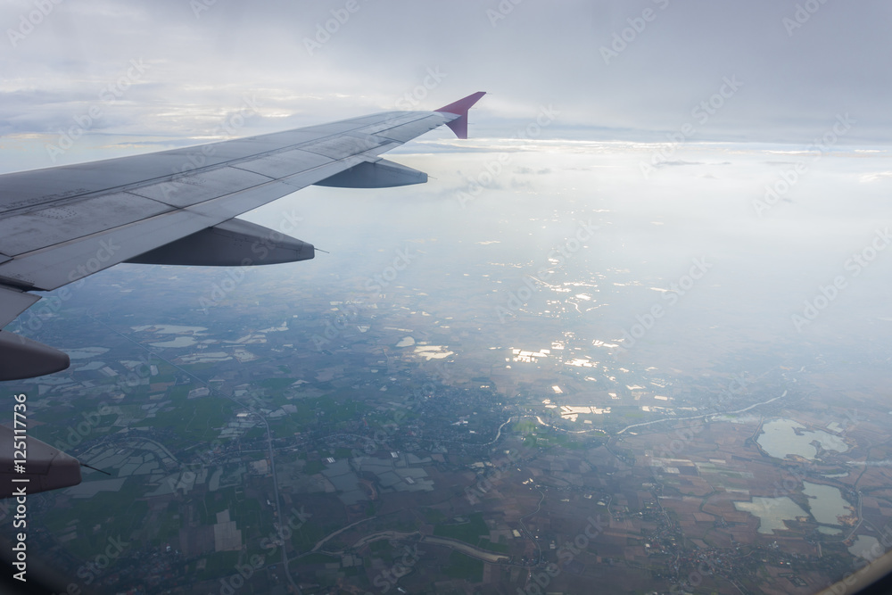 View of beautiful clouds and wing of airplane from window View of beautiful clouds and wing of airplane from window