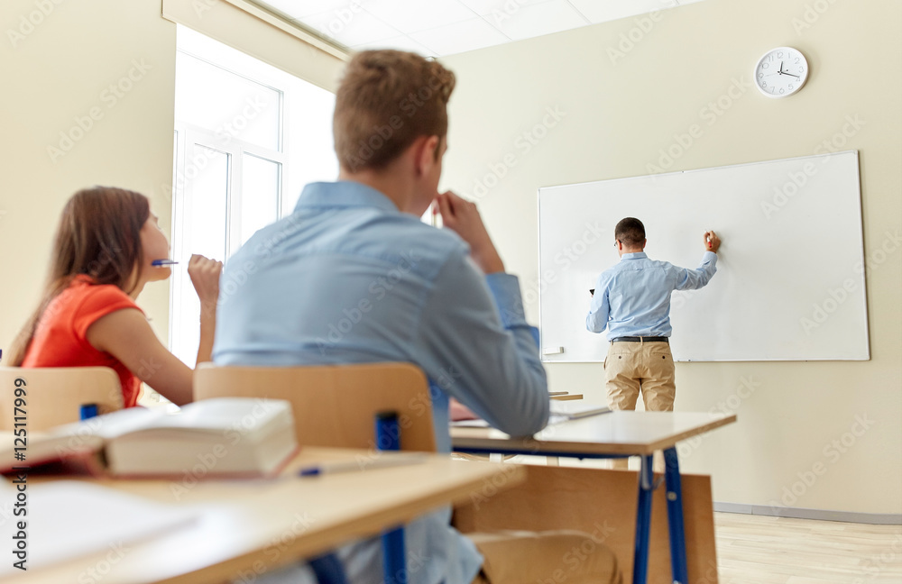 students and teacher writing on school white board students and teacher writing on school white board