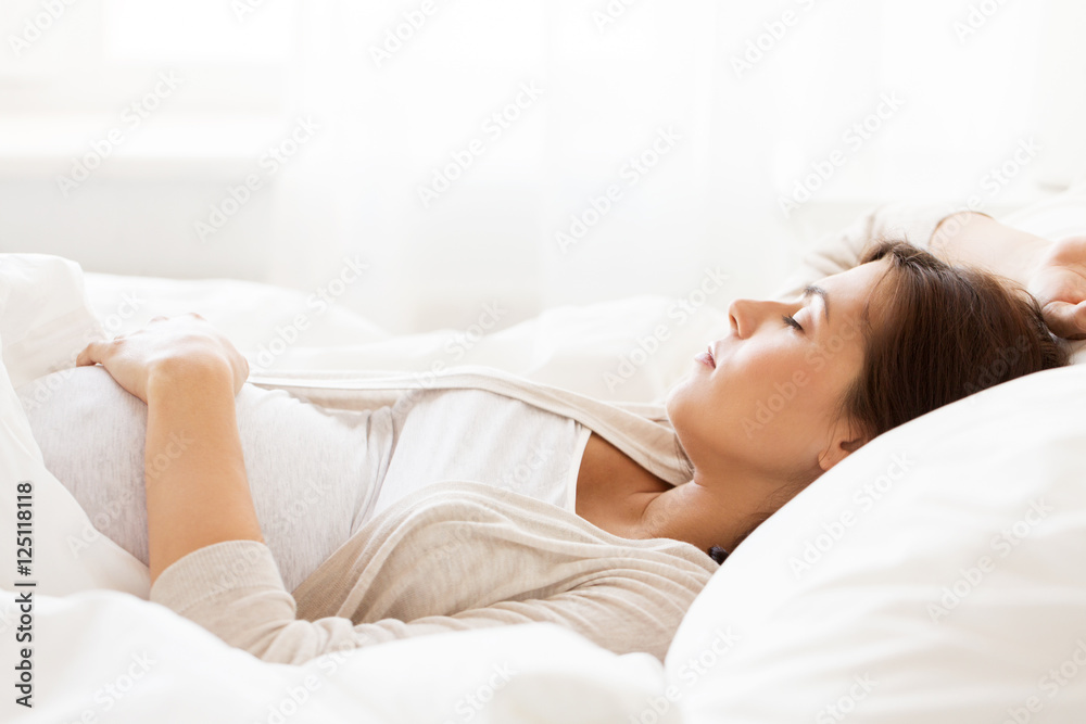 happy pregnant woman sleeping in bed at home happy pregnant woman sleeping in bed at home