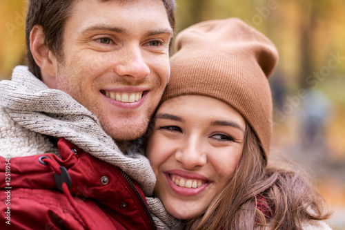 close up of happy young couple in autumn park