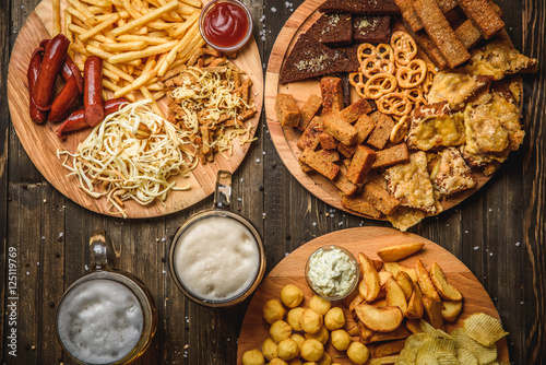 snacks to beer on wooden background top view