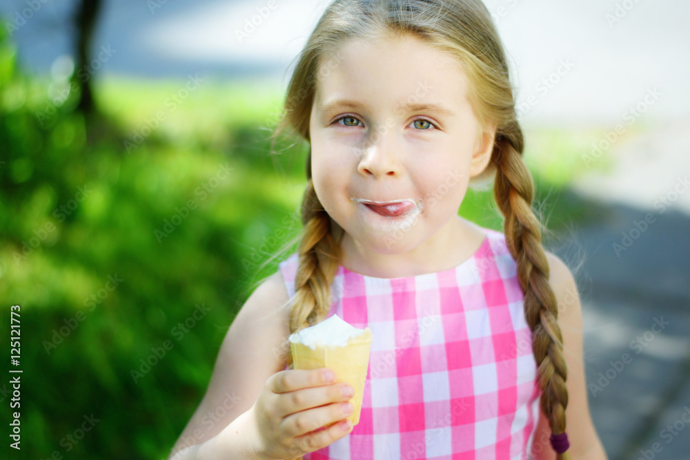Adorable little girl with tasty ice cream on summer Adorable little girl with tasty ice cream on summer