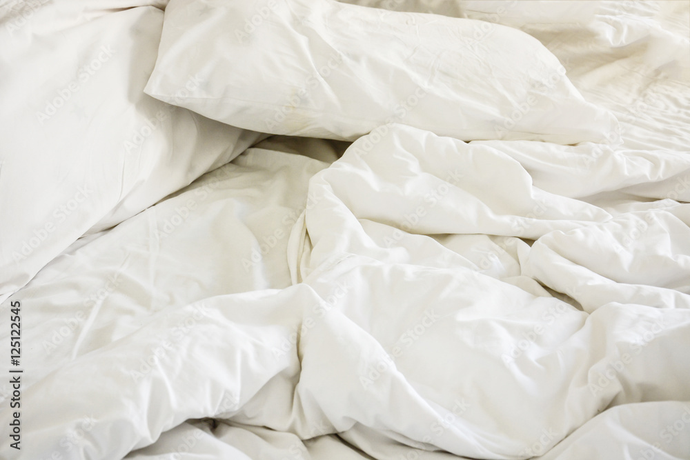 Obraz premium white pillow on bed and with wrinkle messy blanket in bedroom, f