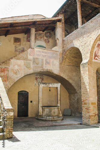 A courtryard of a medieval building in San Gimignano , Tuscany, Italy photo