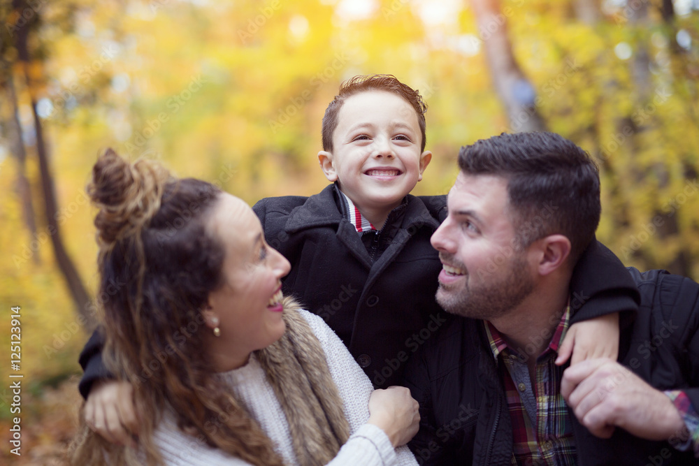 happy young family spending time outdoor in the autumn park happy young family spending time outdoor in the autumn park
