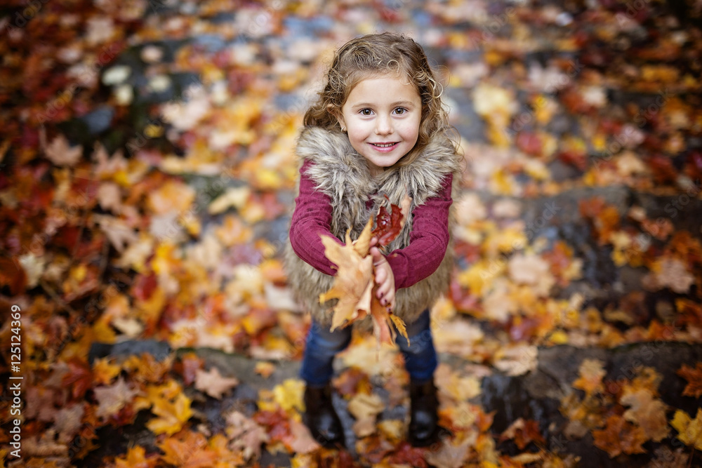 Adorable little girl in a autumn forest Adorable little girl in a autumn forest