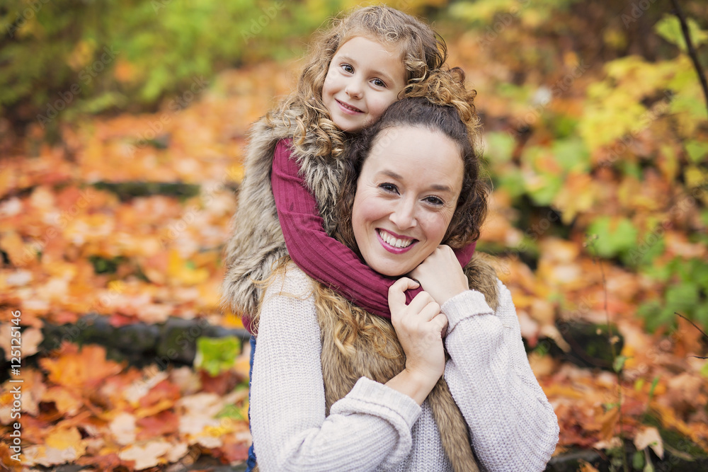 Young mother playing with her daughter in autumn park Young mother playing with her daughter in autumn park