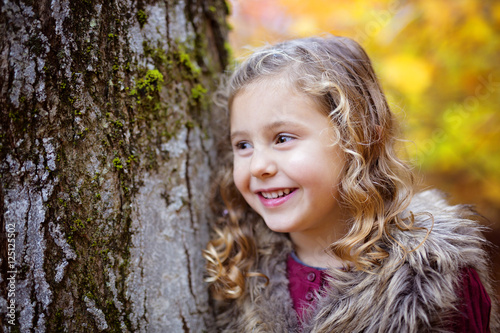Adorable little girl in a autumn forest