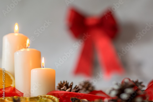 White candles and red ribbon