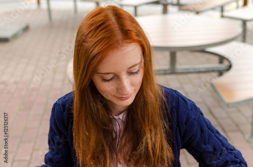 Young red woman walking in the city