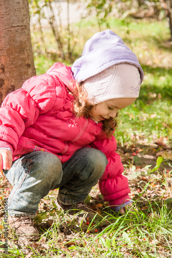 happy little child, baby girl playing in the autumn on the nature walk outdoors