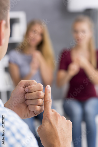 Language teacher showing new sign to his students