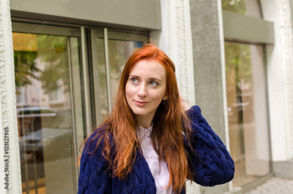 Fototapeta premium Young red woman walking in the city