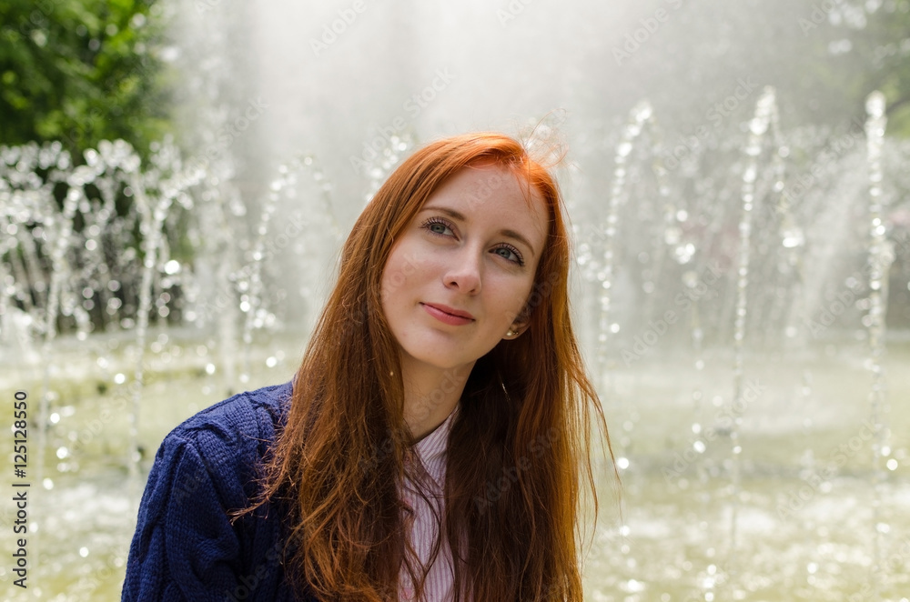 Fototapeta premium Young red woman walking in the city