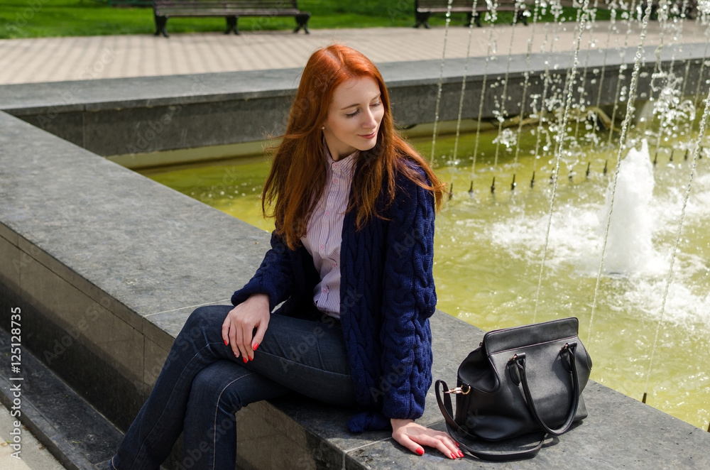 Fototapeta premium Young red woman walking in the city