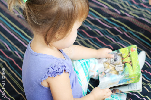 Child reading book with fairy tales