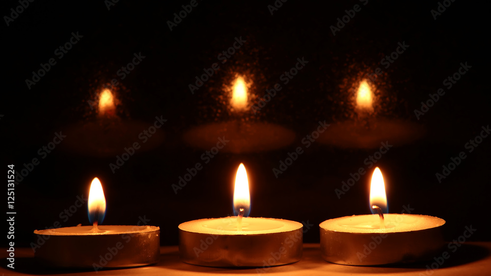 Burning candles on dark background Burning candles on dark background