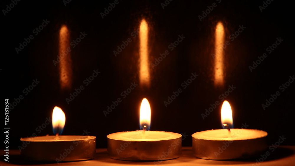 Burning candles on dark background Burning candles on dark background