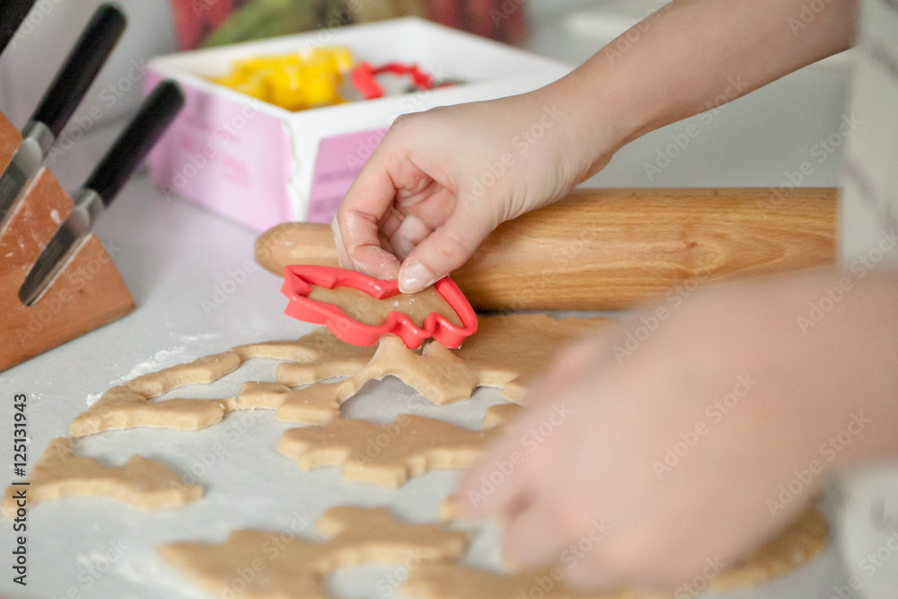 Hands cutting out cookies Hands cutting out cookies