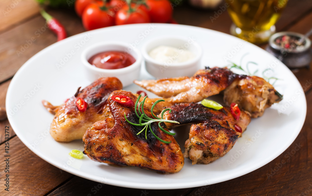 Baked chicken wings in the Asian style on plate.