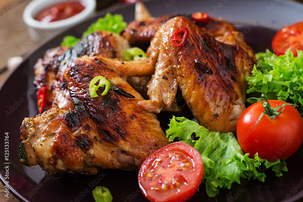 Baked chicken wings in the Asian style on plate. Baked chicken wings in the Asian style on plate.